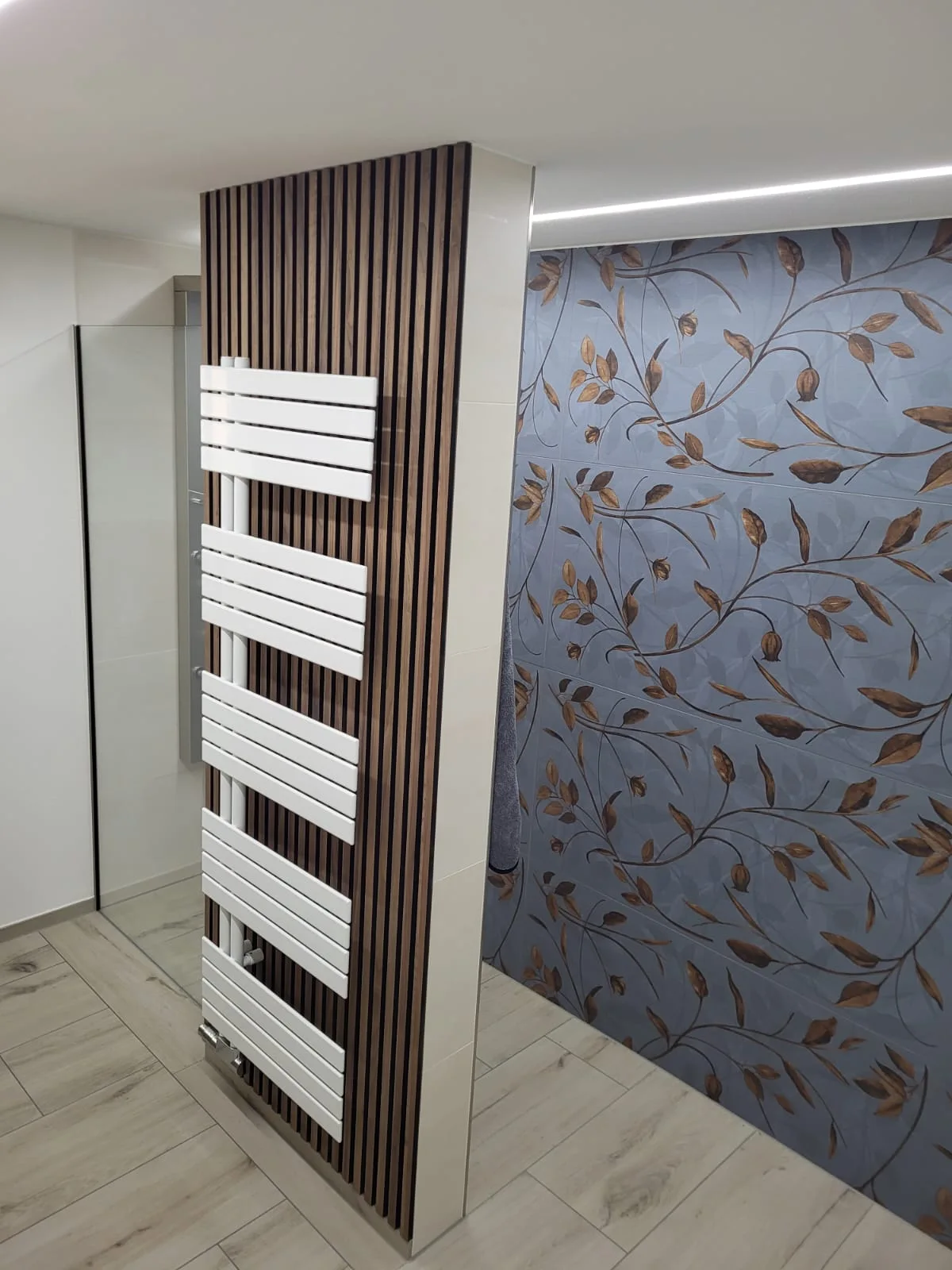 Individuelles Badezimmer mit Holzoptik und floralem Fliesendekor
